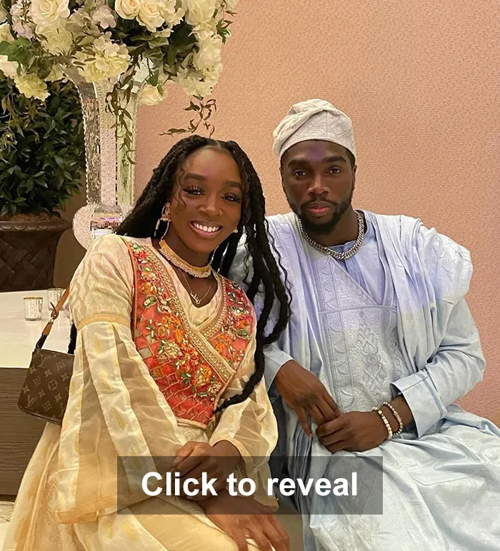 A elegantly dressed couple sitting together and smiling. Many couples look alike, sharing similar features, a bizarre phenomenon.