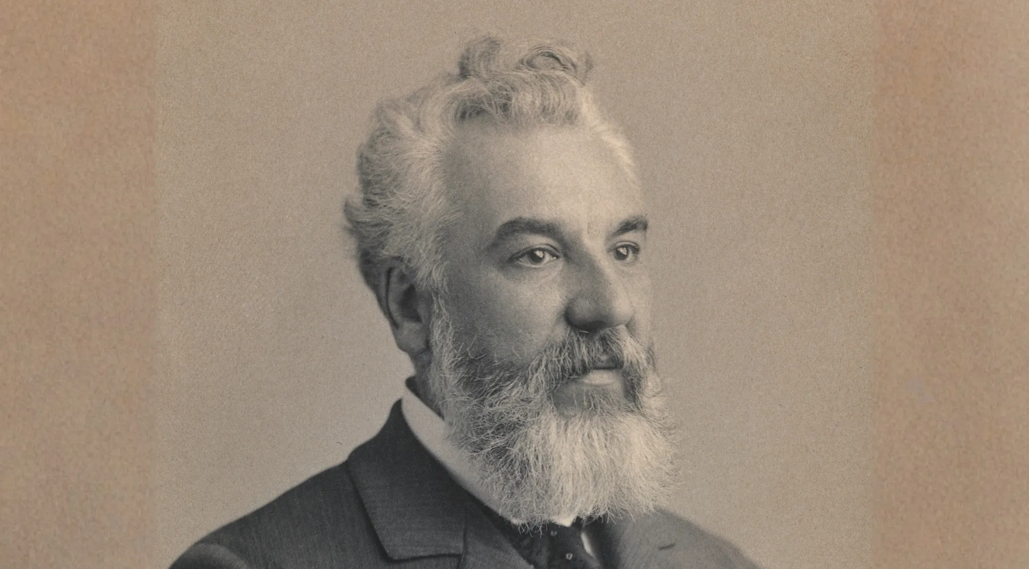 Sepia-toned portrait of Alexander Graham Bell with a beard and mustache, inventor of the telephone for general knowledge for kids.