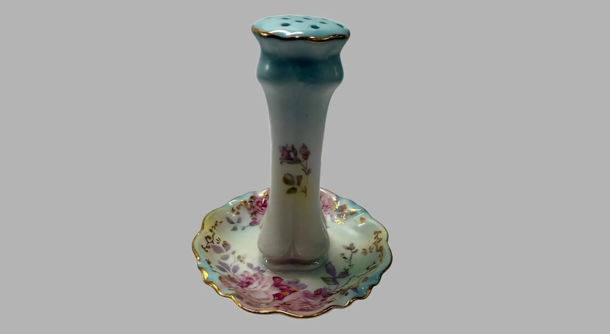 Vintage item: light blue and white vase with gold trim and pink floral designs on a light gray background.