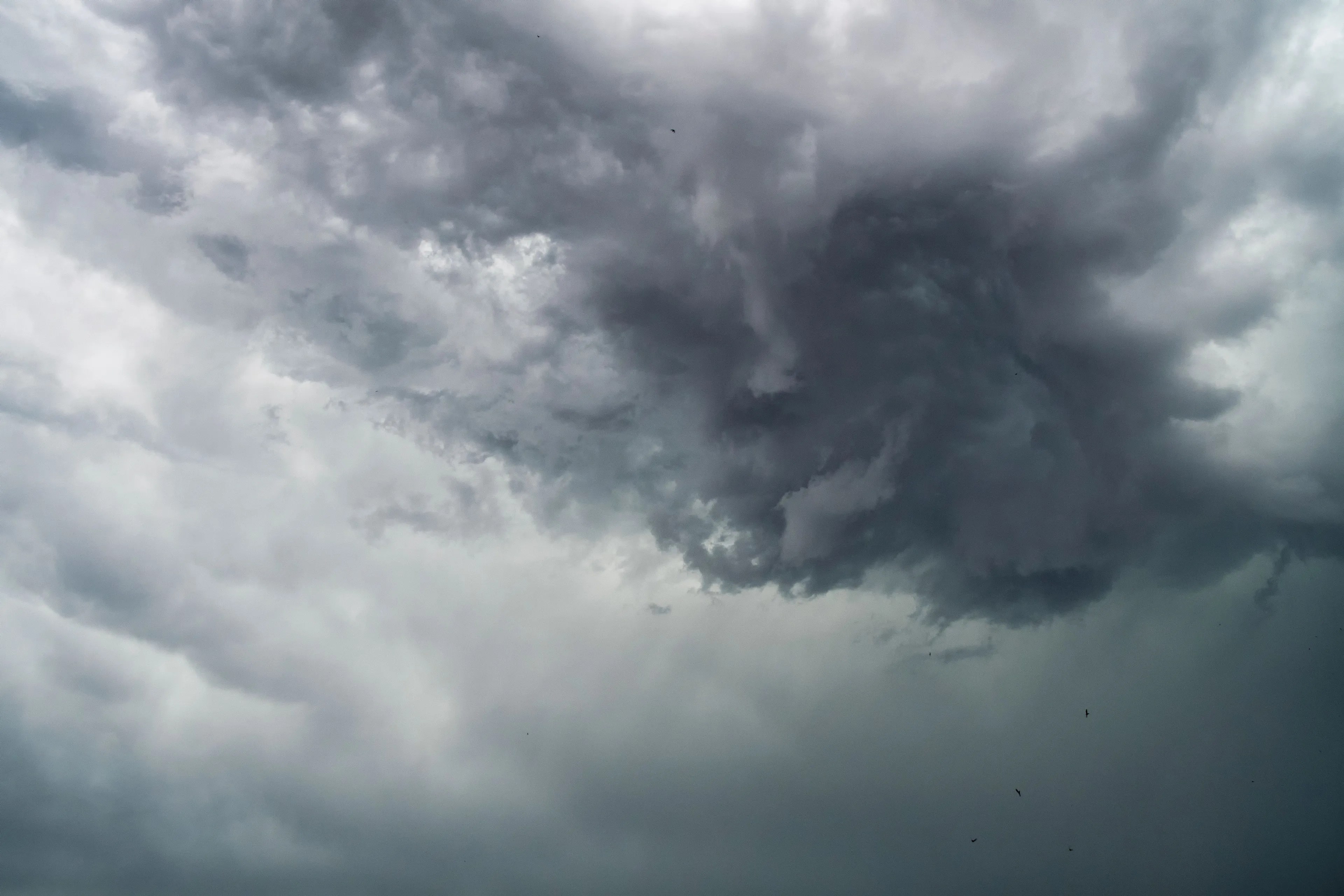 A stormy, dark gray sky with swirling clouds; the storm seems quiet but hints at intensity. Japanese Cube Personality.