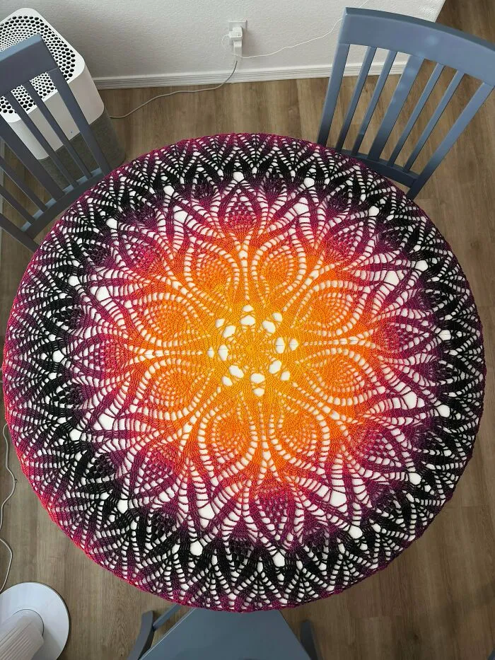 Crochet table cover with vibrant sunset gradient pattern