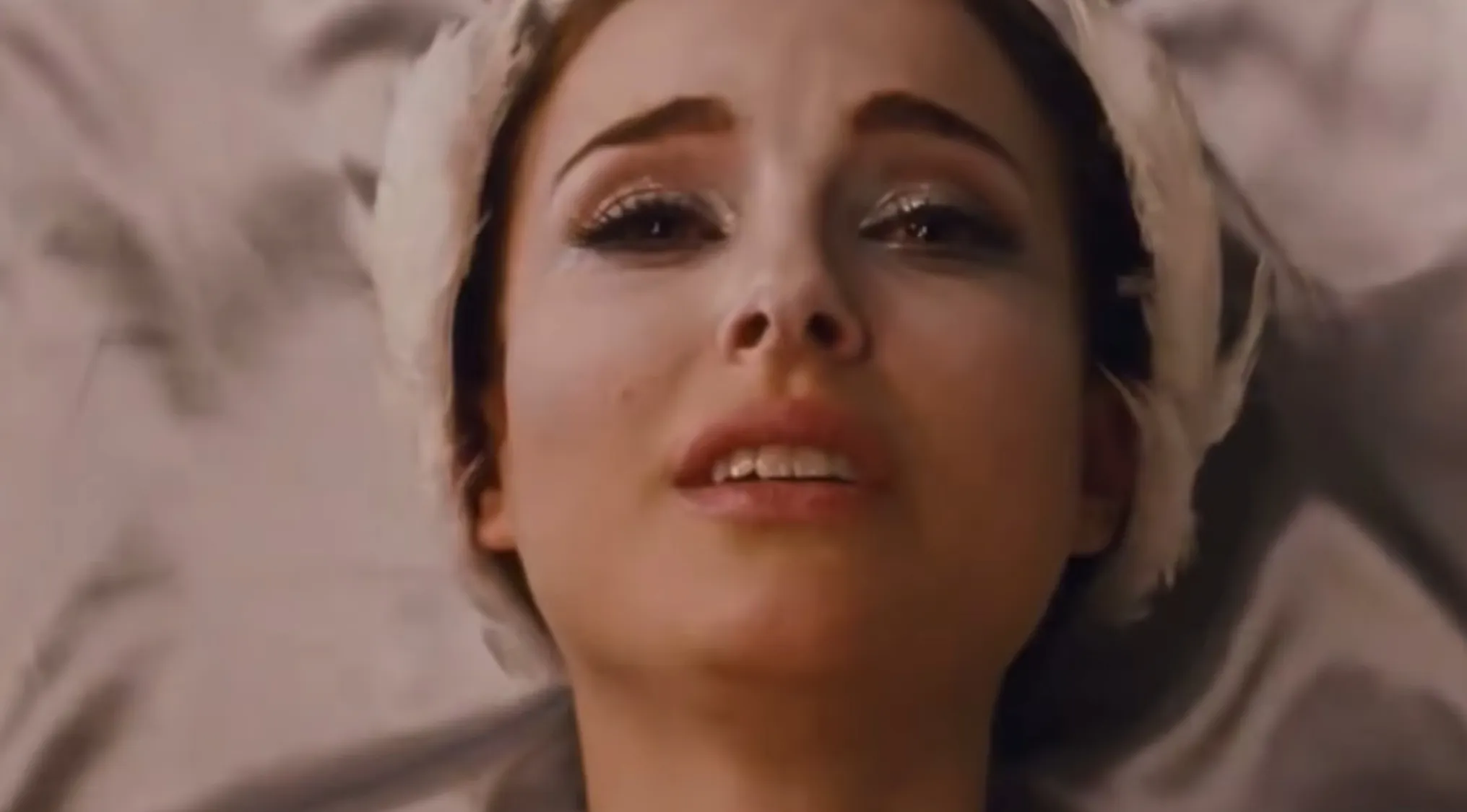Name the film by the ending scene, a woman with pale makeup and white feather hairpiece looks up with emotion.