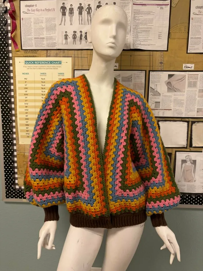 Colorful striped crochet cardigan on a mannequin