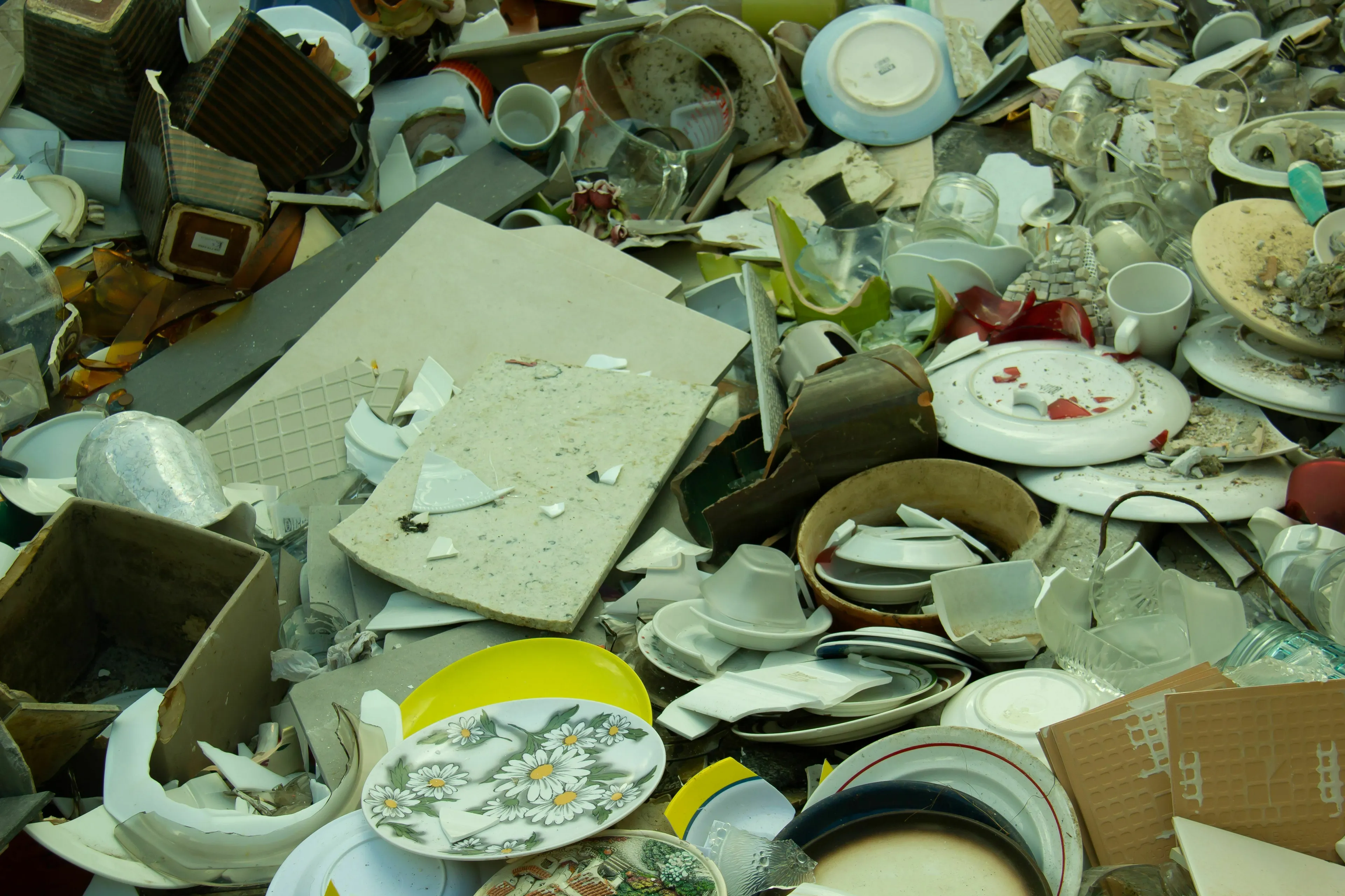 A pile of broken dishes and pottery, showing a mess and a mythological trickster's approach to explaining it.