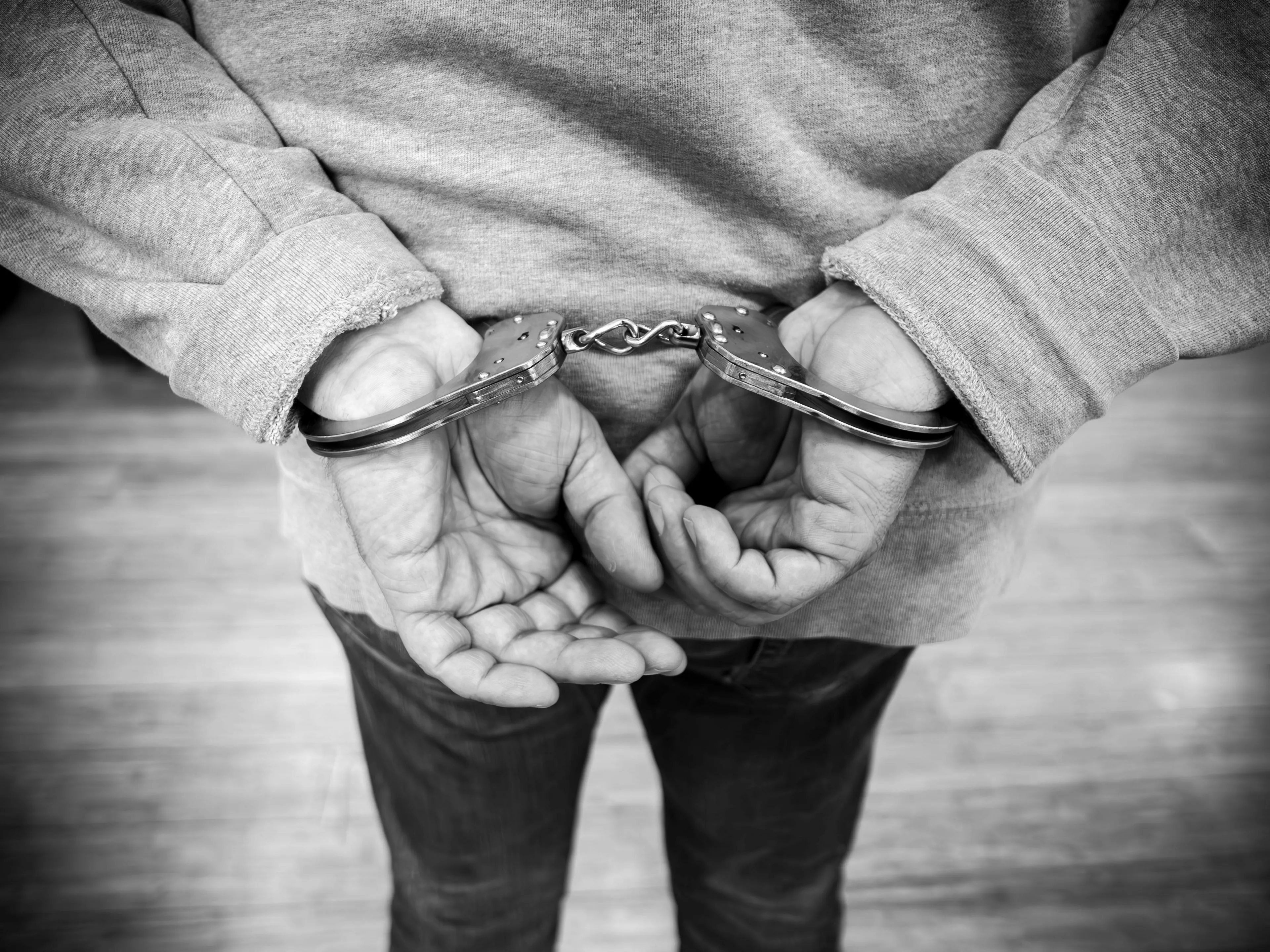 Mythological trickster caught in handcuffs, facing the consequences of a trick.
