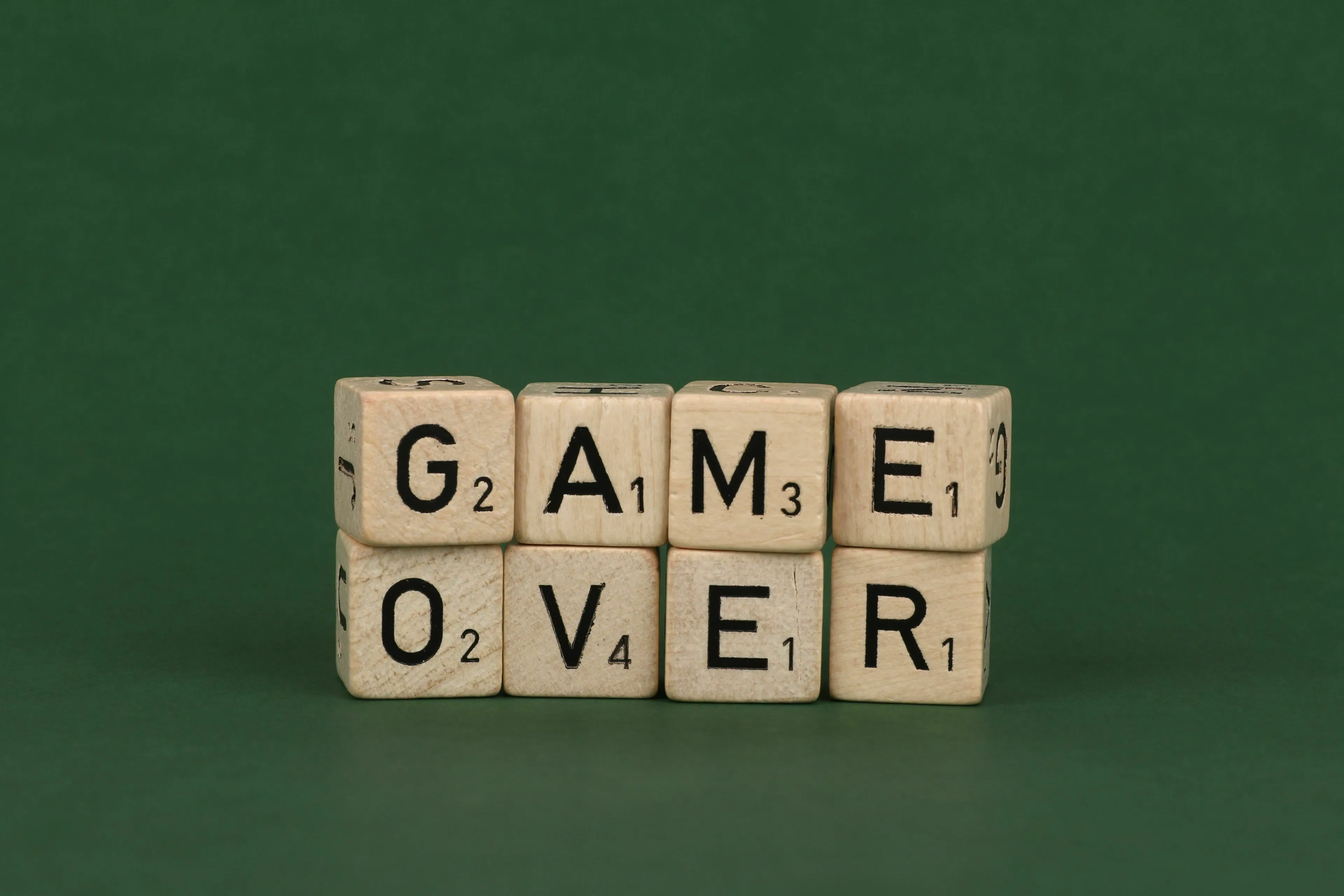 Scrabble tiles spelling out GAME OVER, symbolizing losing a contest for a mythological trickster quiz.