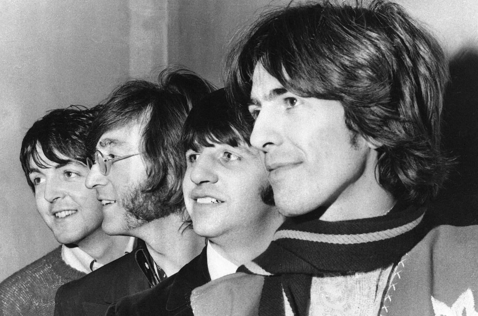 Black and white close-up of The Beatles members Ringo Starr, John Lennon, Paul McCartney, and George Harrison.