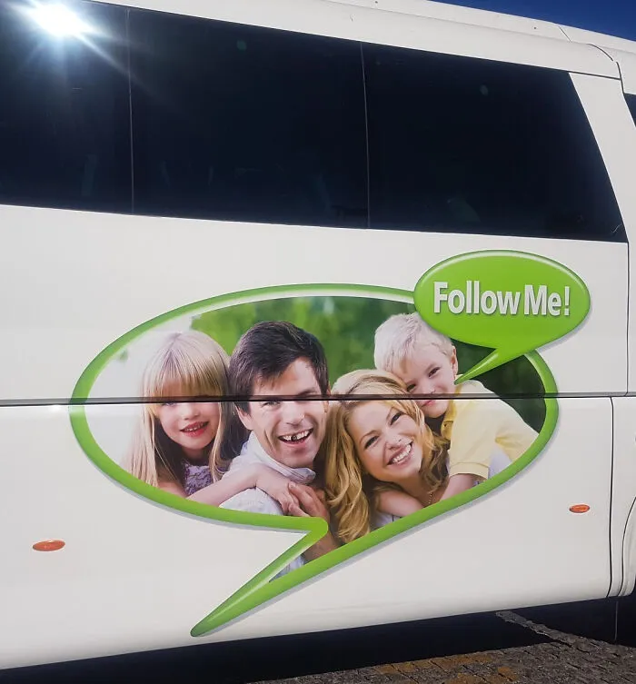 A family smiling inside a speech bubble on a bus, with Follow Me! text. An example of interesting and hilarious ad placement on a bus.