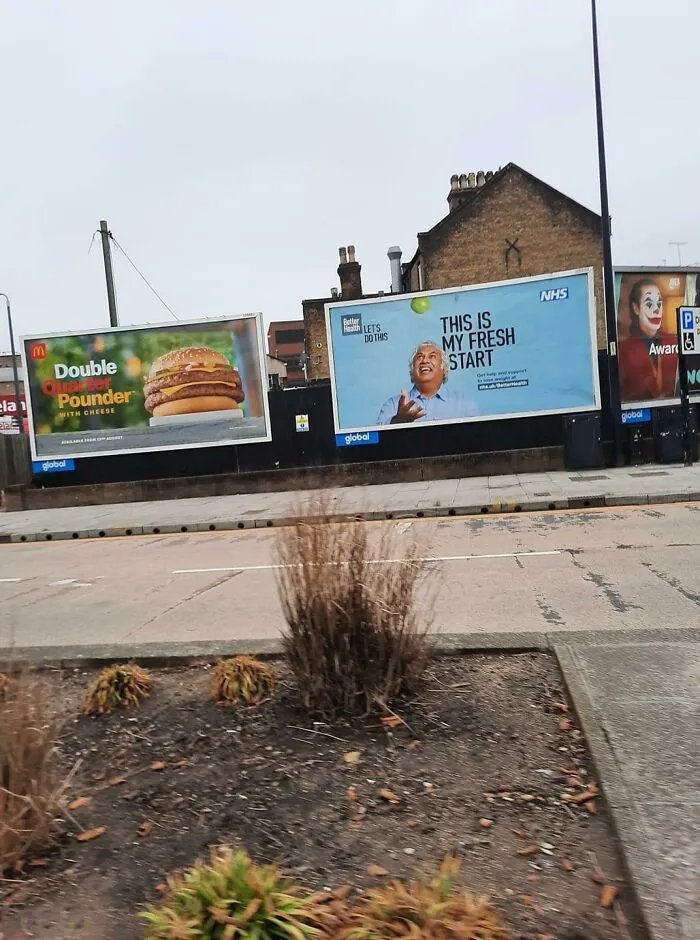 A McDonald's Double Pounder ad next to an NHS ad promoting a fresh start with healthy food, creating an interesting ad placement.