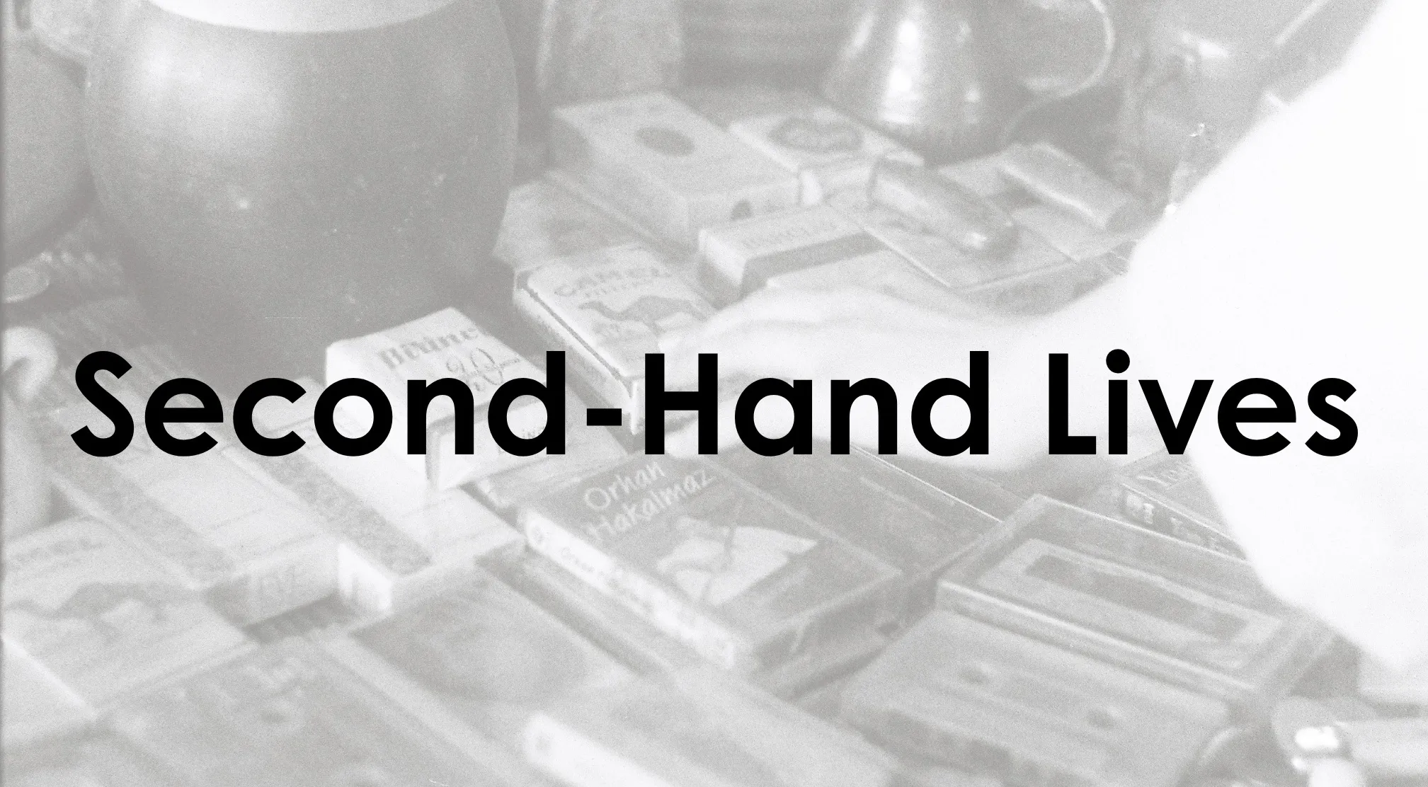 The title Second-Hand Lives in bold black text over a blurred, grayscale background of old items. Guess the book.