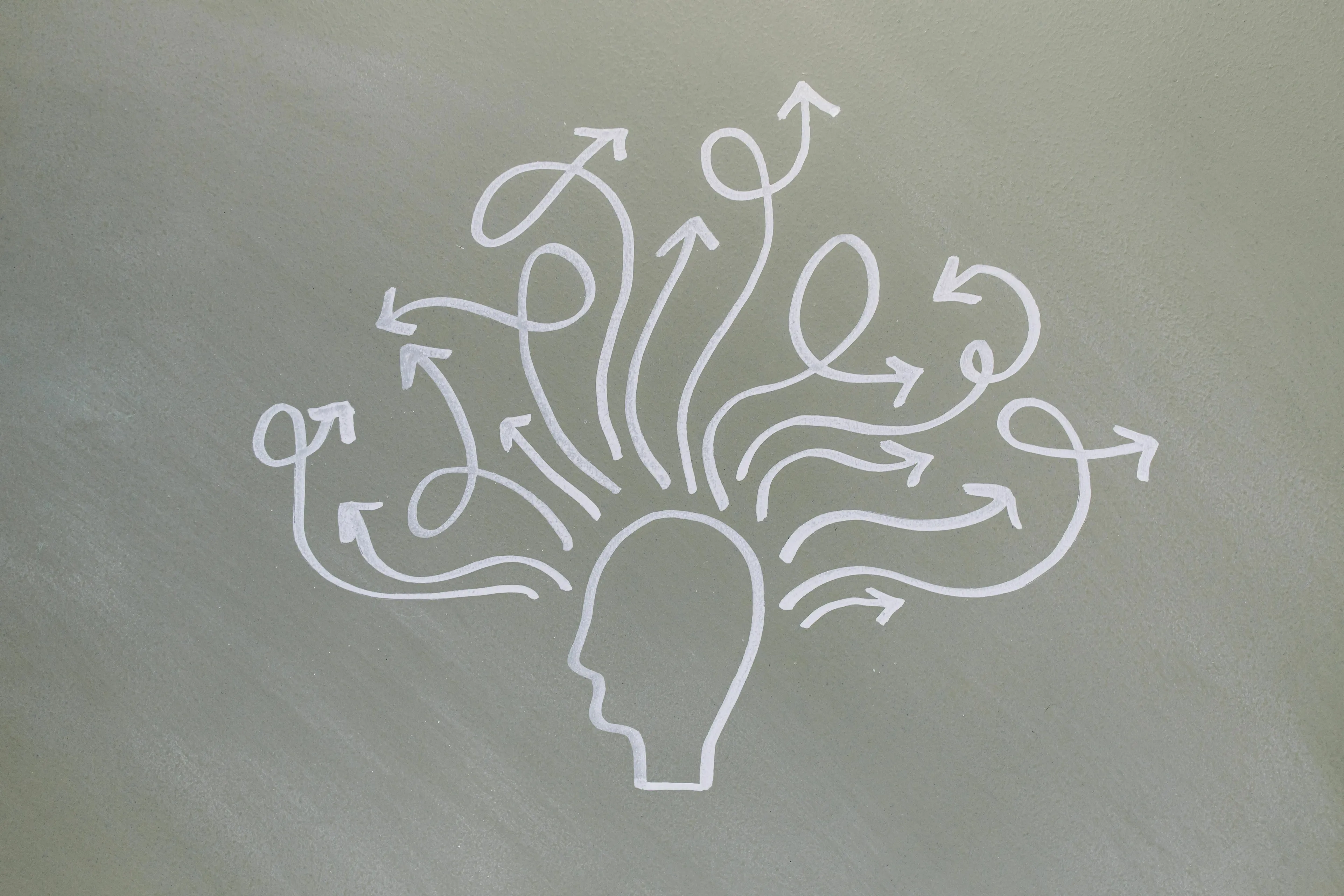 An illustration of a head with many arrows pointing in different directions, symbolizing putting off a decision and repeating Angel Numbers.