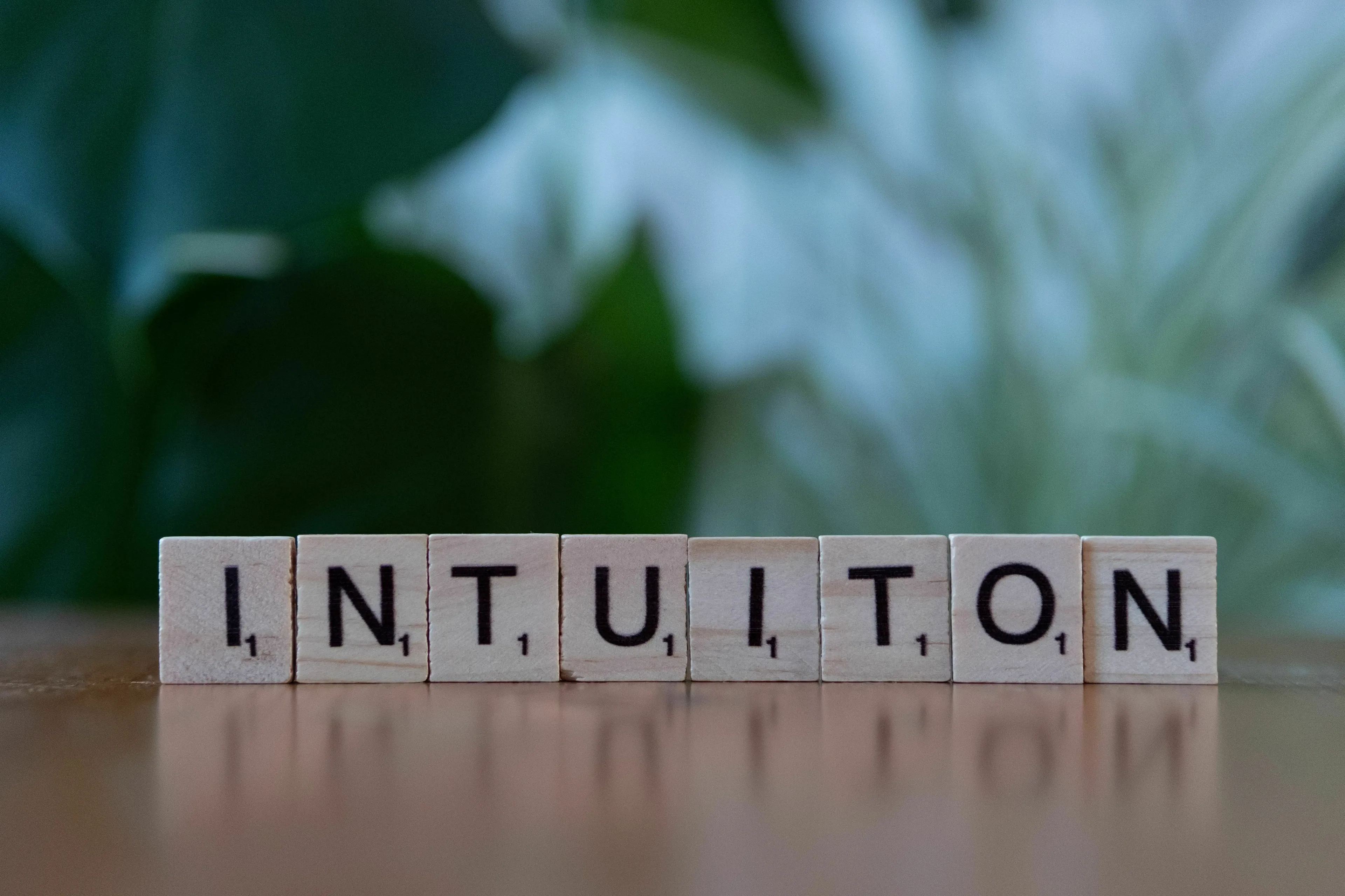 The word INTUITION spelled out with scrabble tiles. What's Your Angel Number? Do you trust your gut feeling?