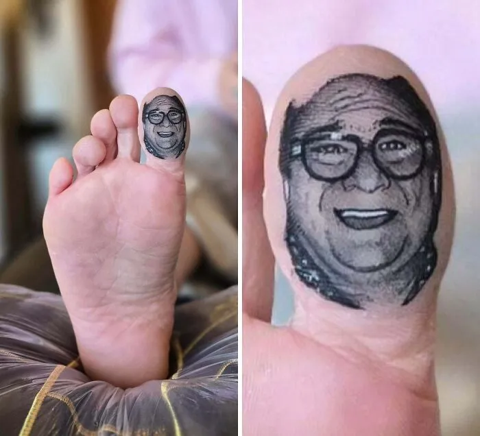 A detailed portrait tattoo of Danny DeVito on a big toe, a humorous example of stunning tattoos.
