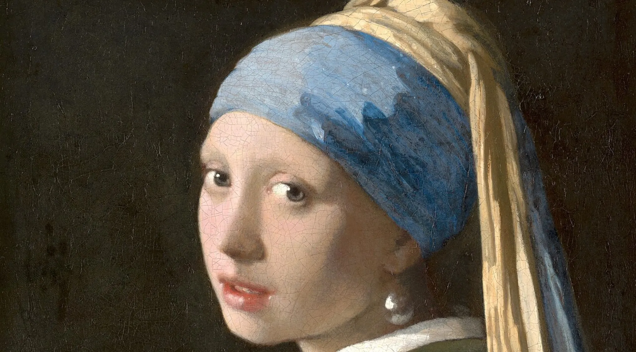 Close-up of the iconic painting Girl with a Pearl Earring by Vermeer, suitable for a general knowledge pub quiz.