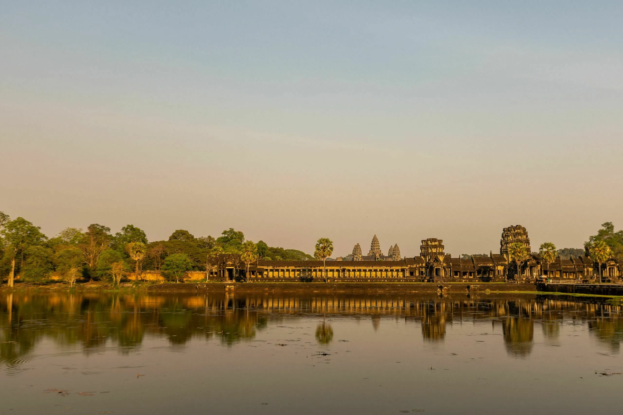 Panoramic view of the ancient Angkor temples reflected in water, a key location for a general knowledge pub quiz.