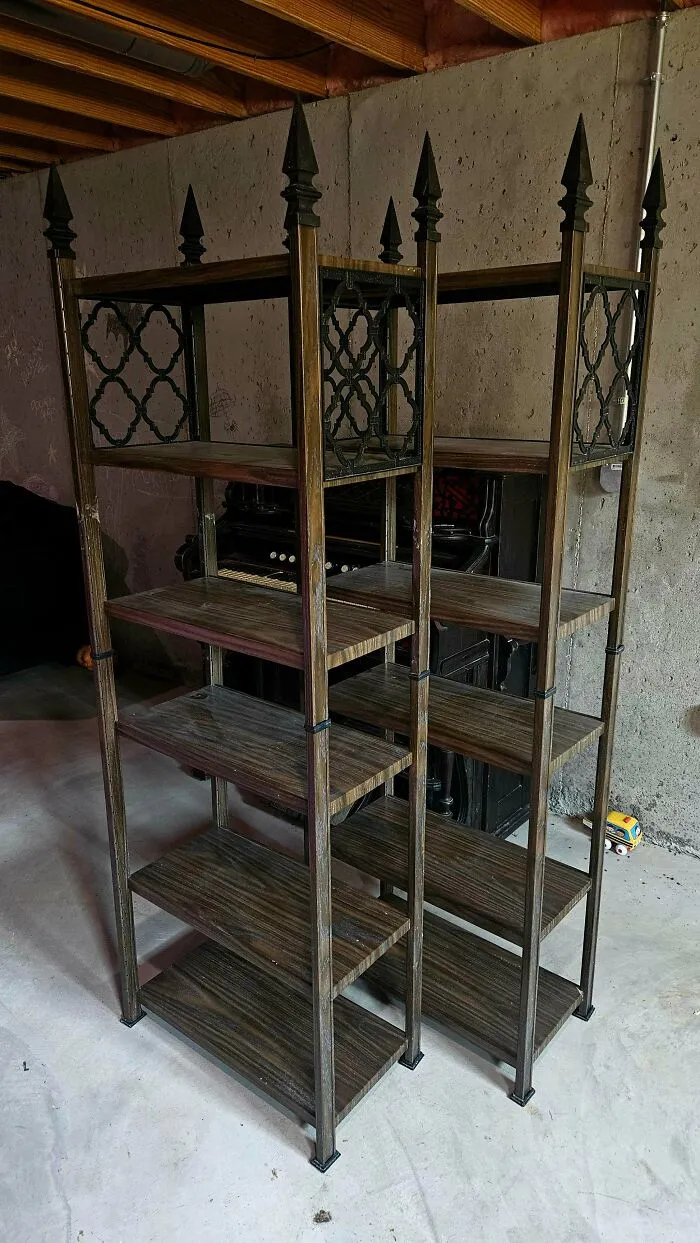 A pair of unique, ornate metal and wood shelving units discovered at a thrift store, a true jackpot find.