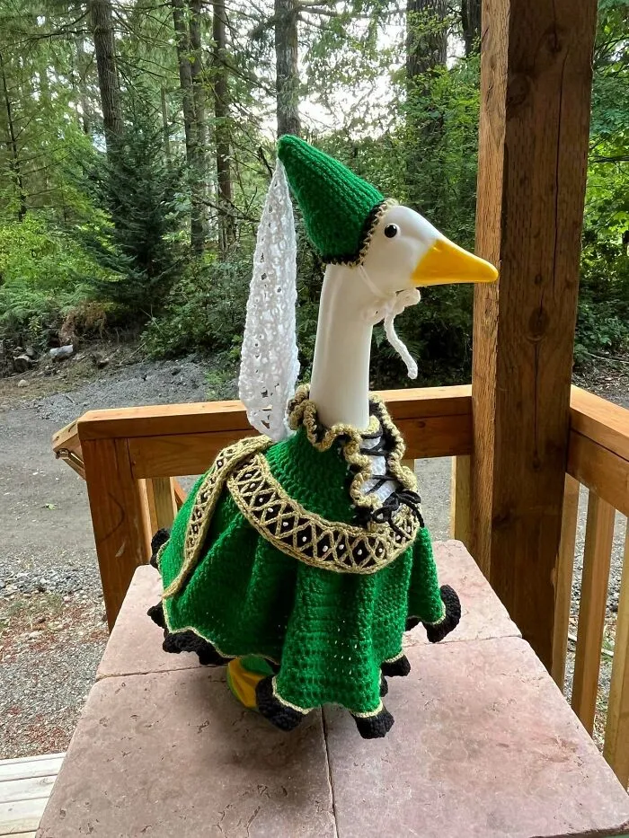 Crochet goose costume with green dress and hat on porch