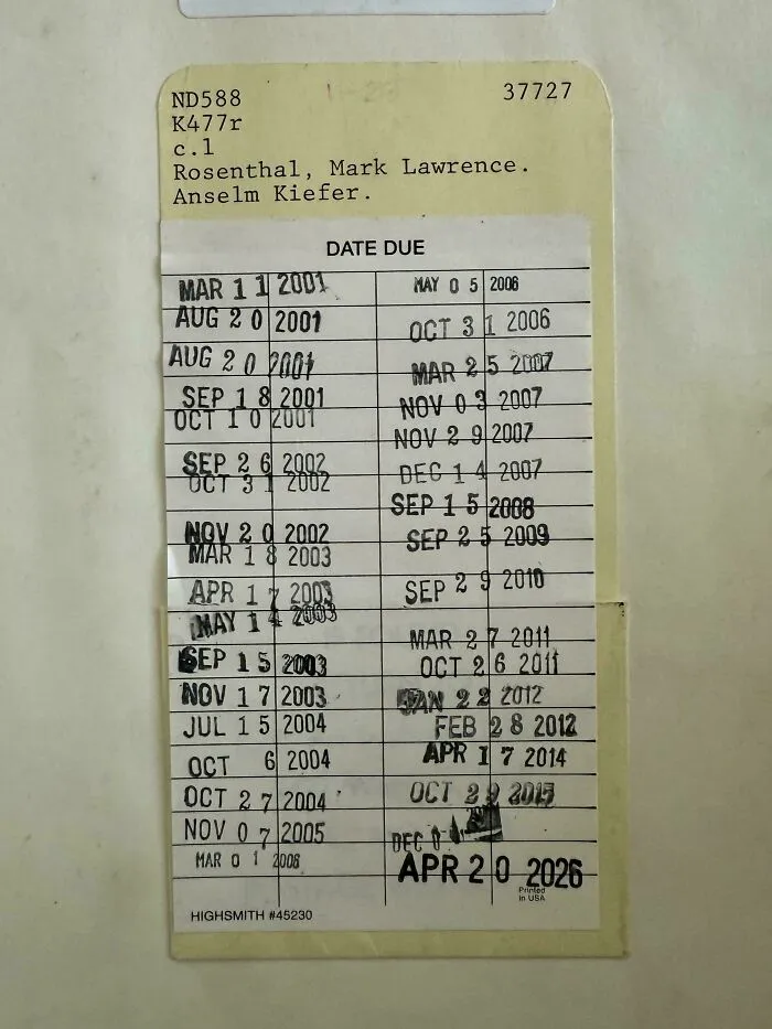 A library card with stamped due dates, highlighting how much the past has changed in terms of borrowing books, a piece of ephemera.