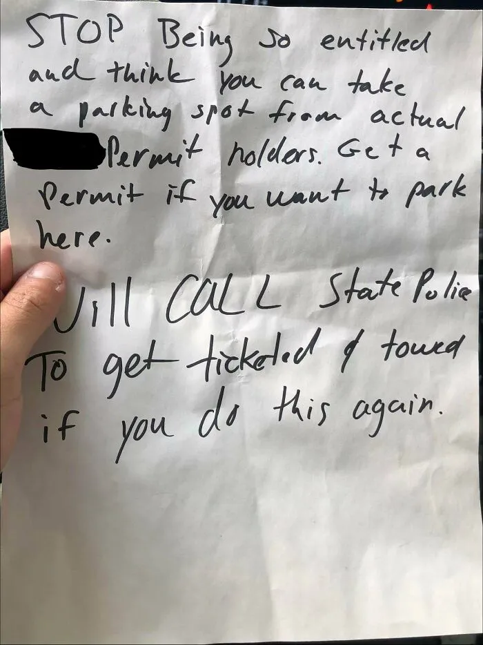 A handwritten note threatening police action for poor parking, a clear sign of jerk neighbors.
