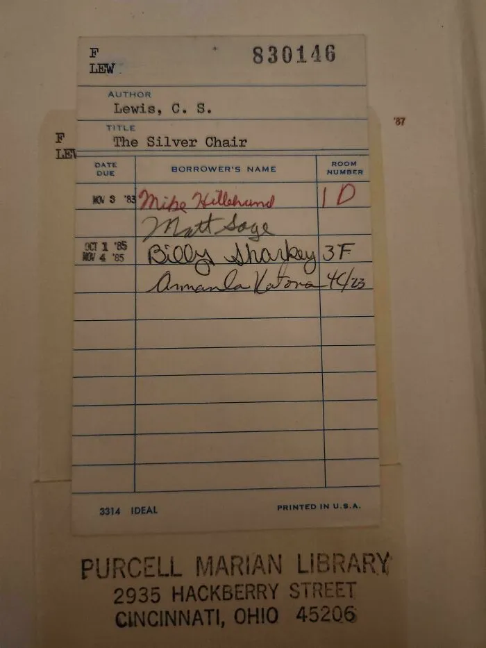 A vintage library card with handwritten names and dates, showcasing fascinating pieces of ephemera from the past.