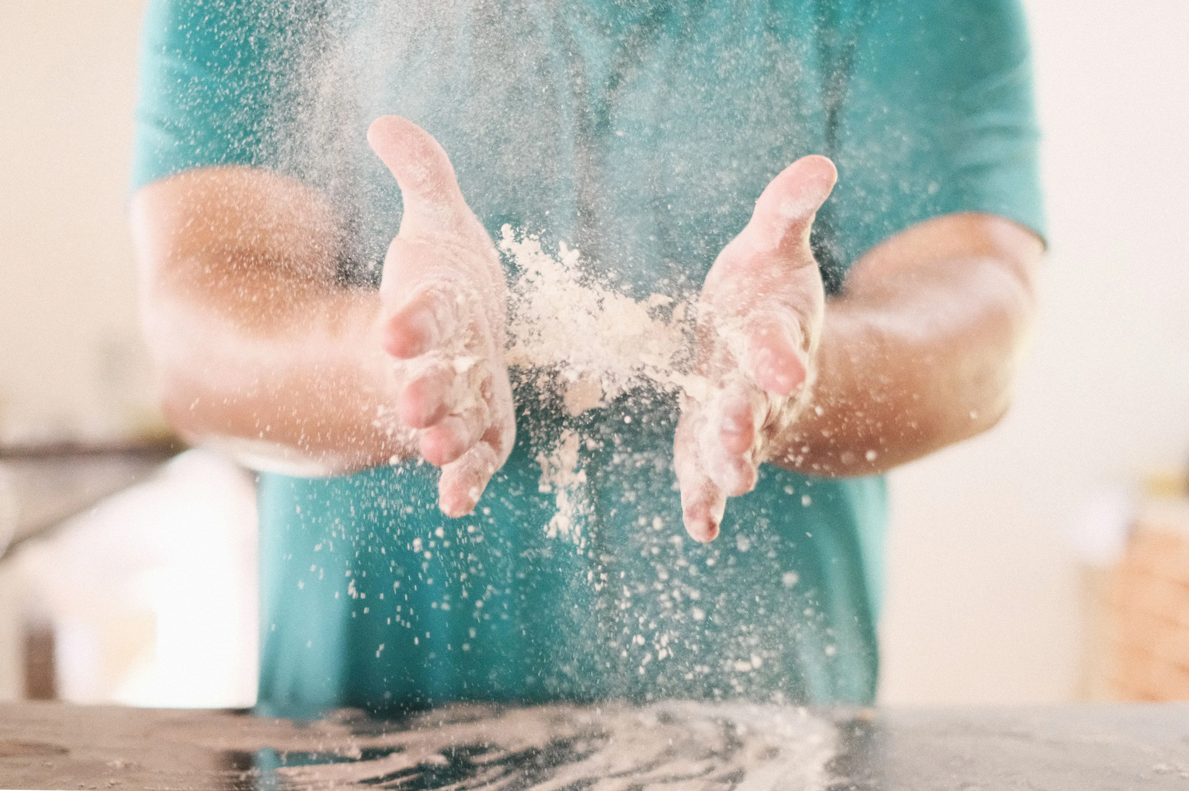 Hands clapping together, creating a cloud of white flour dust, for a General Knowledge Quiz.