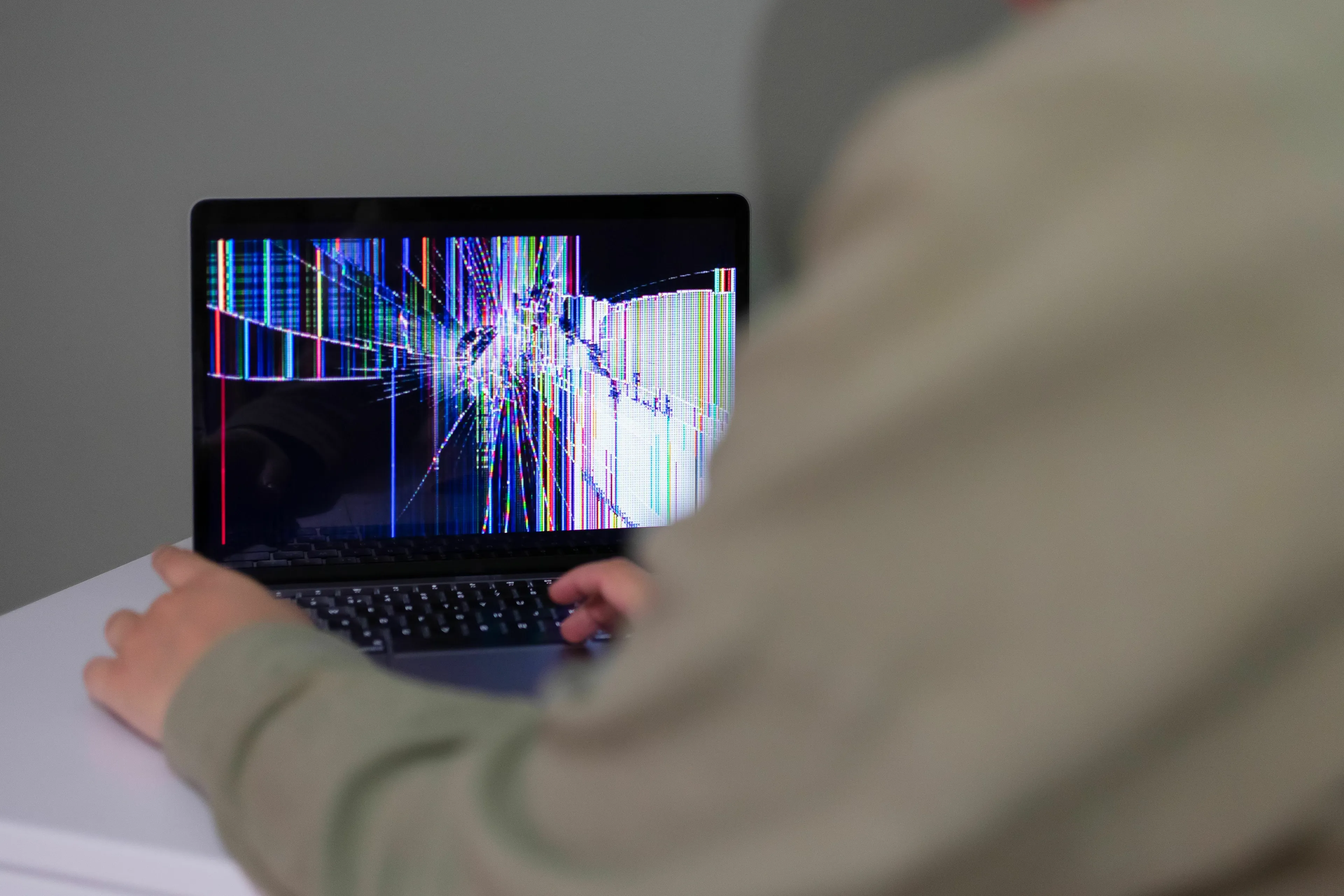 A person looking at a laptop with a cracked screen. What kind of liar are you when at fault for something small?