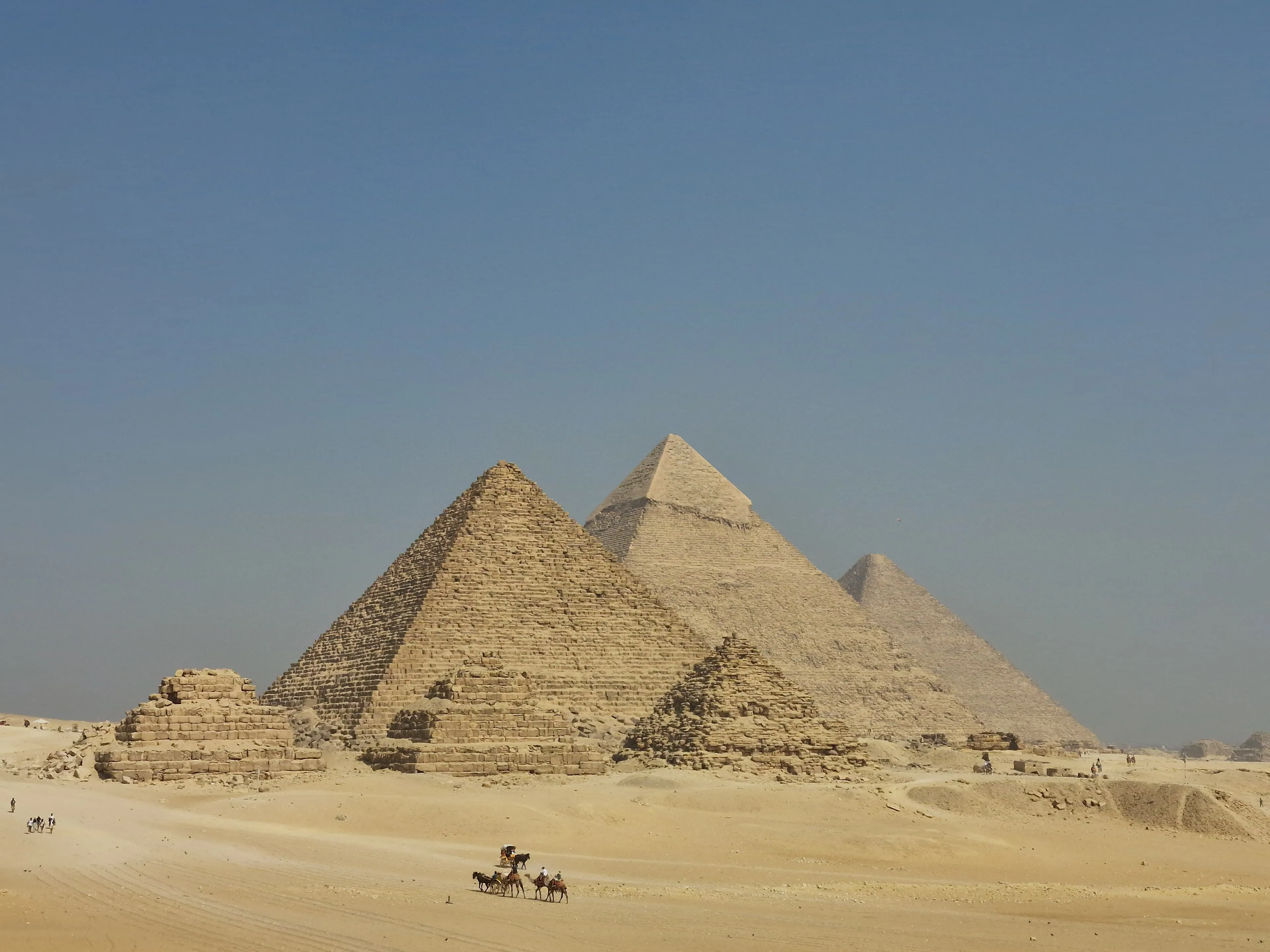 The Pyramids of Giza in a desert landscape, a landmark to exaggerate visiting.