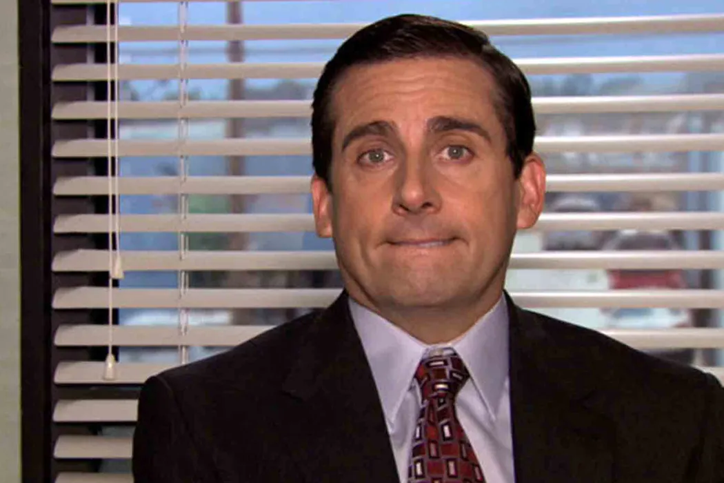 A fictional character, Michael Scott, from The Office, looks sheepish; his lying style is transparent and awkward.