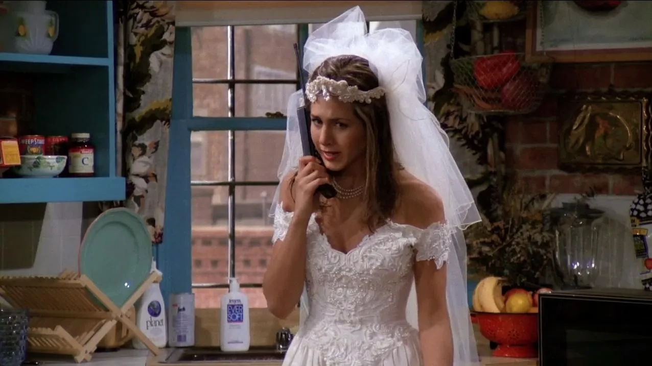 Rachel Green in a wedding dress, on the phone, exemplifying Rachel Green's lying style.