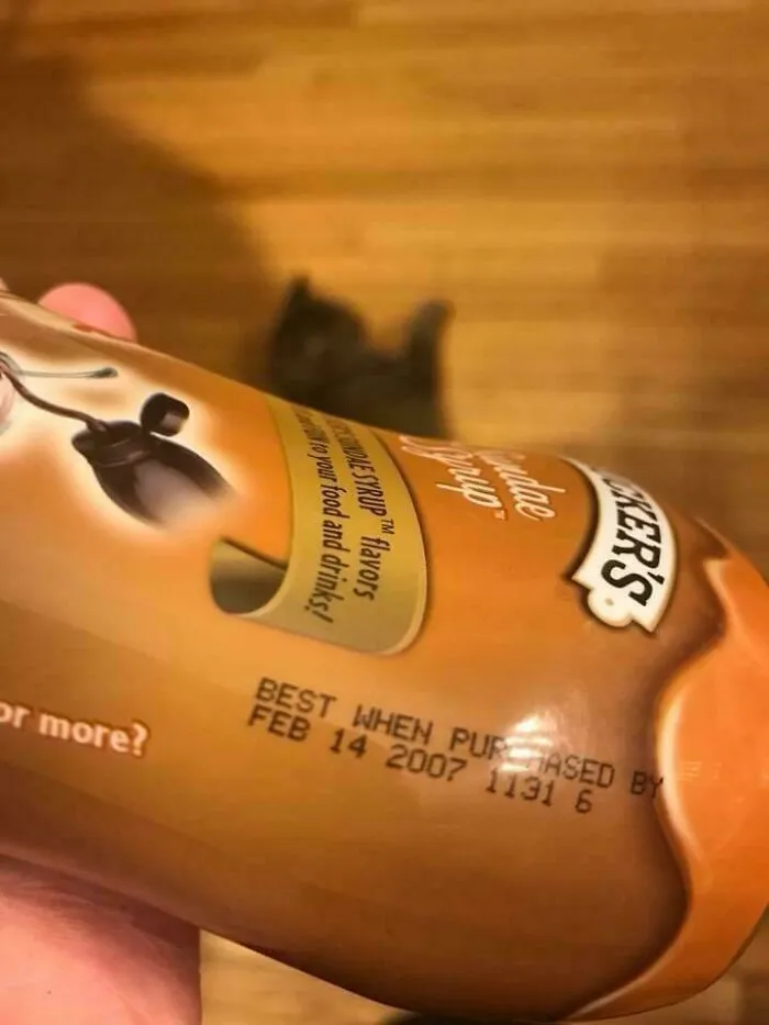 Chocolate syrup bottle with a Best When Purchased By date of FEB 14 2007: An old product found at home.