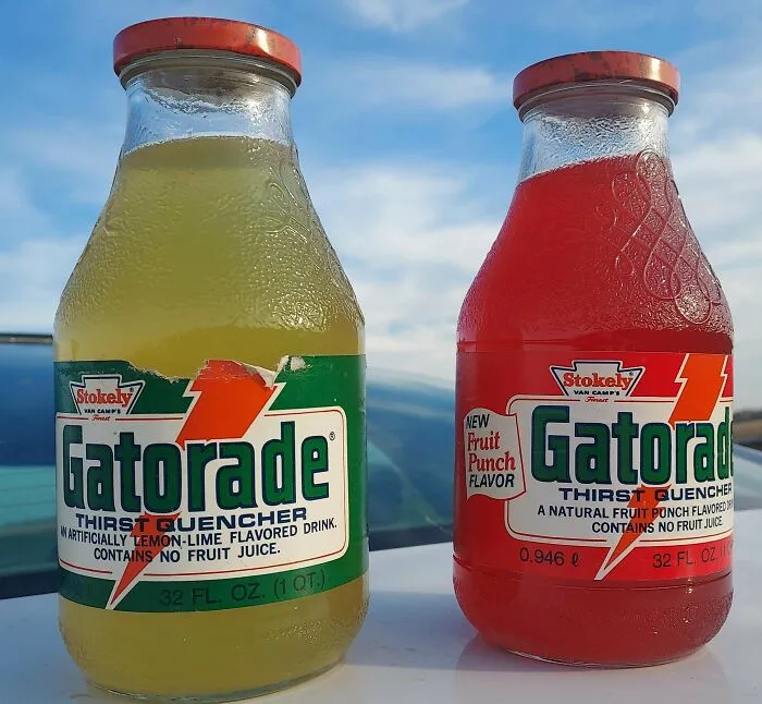 Two vintage glass bottles of Gatorade, a lemon-lime and a fruit punch flavor. These old products were found at home.