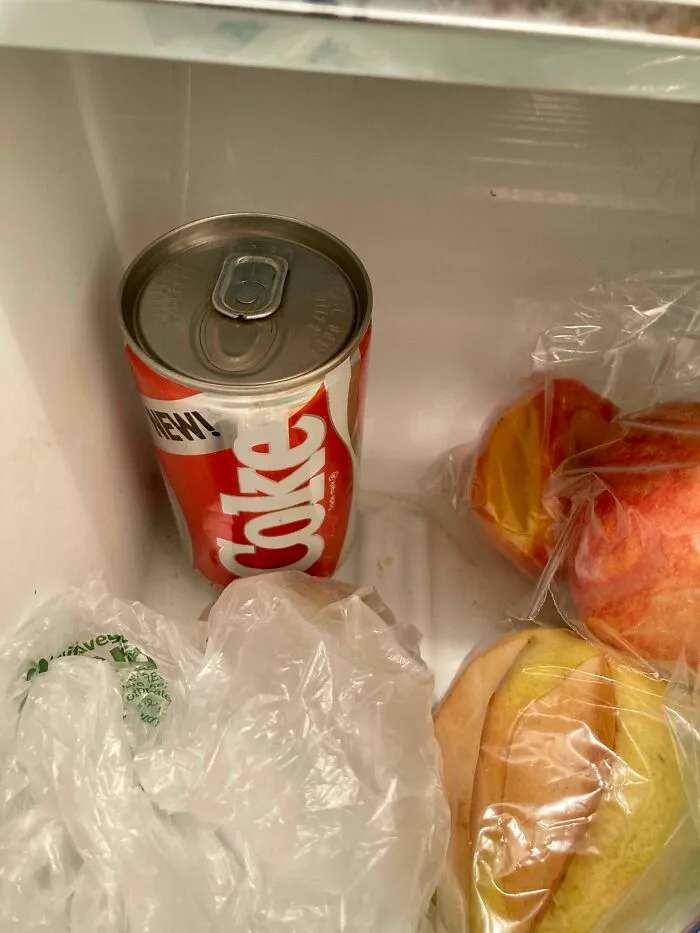 An old Coke can with a red and white label, an old product found at home.