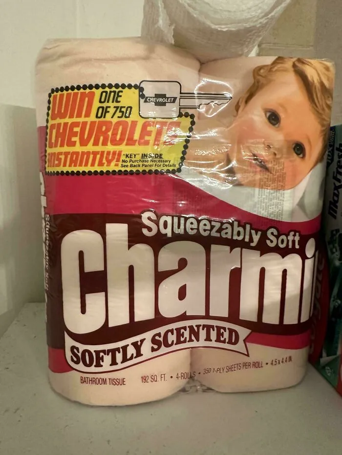 A vintage Charmin toilet paper package featuring a baby and a Chevrolet key giveaway, an old product found at home.