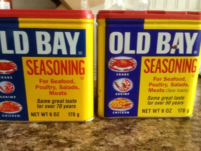 Two containers of Old Bay Seasoning, an old product found at home.