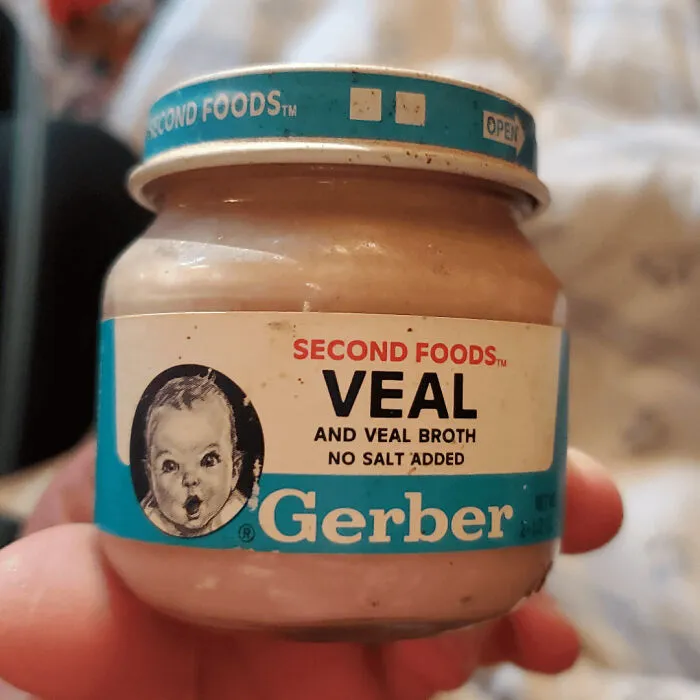 A small glass jar of Gerber Veal baby food, an old product some people never throw away.