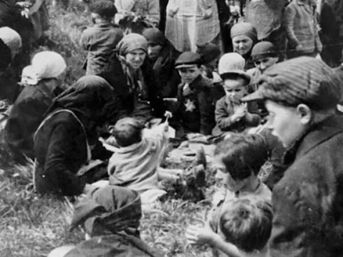 A Jewish Child Shows Her Friends A Dandelion She Found In The Grass While Waiting Outside The Gas Chambers. Auschwitz-Birkenau, May 1944