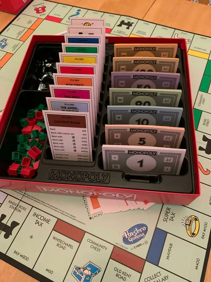 An open box of the Monopoly board game with money and cards neatly organized, a fascinating internet find.