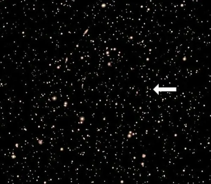 Fascinating finds: A vast starfield with countless celestial objects and an arrow pointing to one.