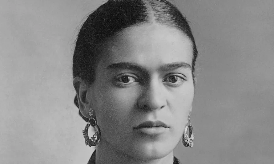 A black and white portrait of Frida Kahlo, a renowned artist.