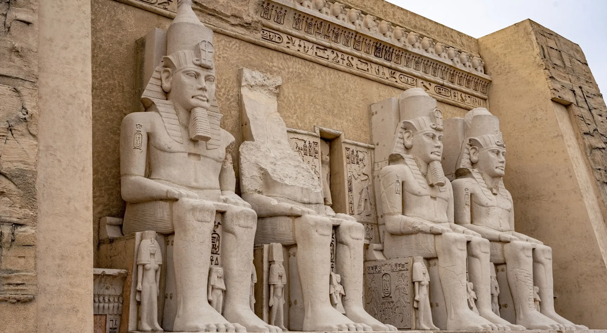 Ancient Egyptian obelisk-like statues carved into a temple wall. Majestic pillars with pharaohs for an FBI quiz.