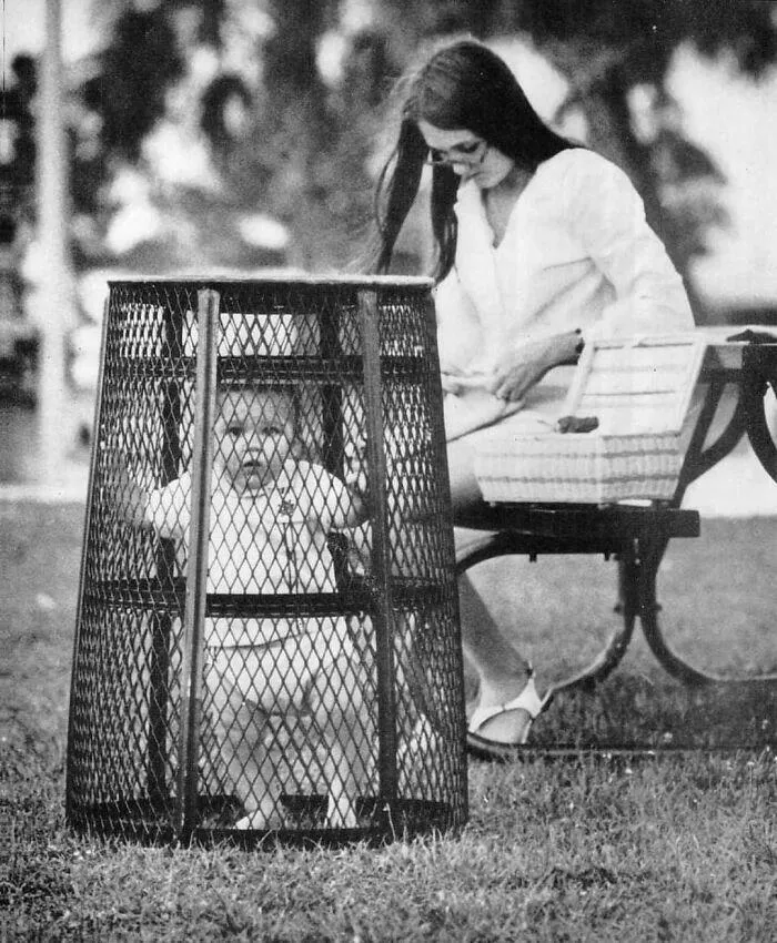 1969. Mom Contains Her Baby In A Central Park's Trash Bin While She Catches Up On Her Crocheting
