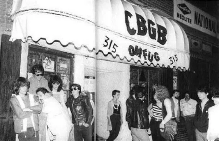 Rare photo from American history of a crowd outside the legendary CBGB music club, showcasing punk rock culture.