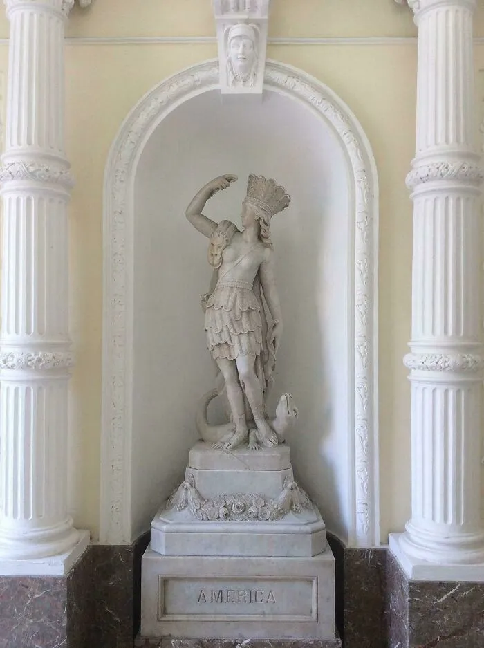 A fascinating photo from American history showing the America statue, a classic marble sculpture in a bright alcove.