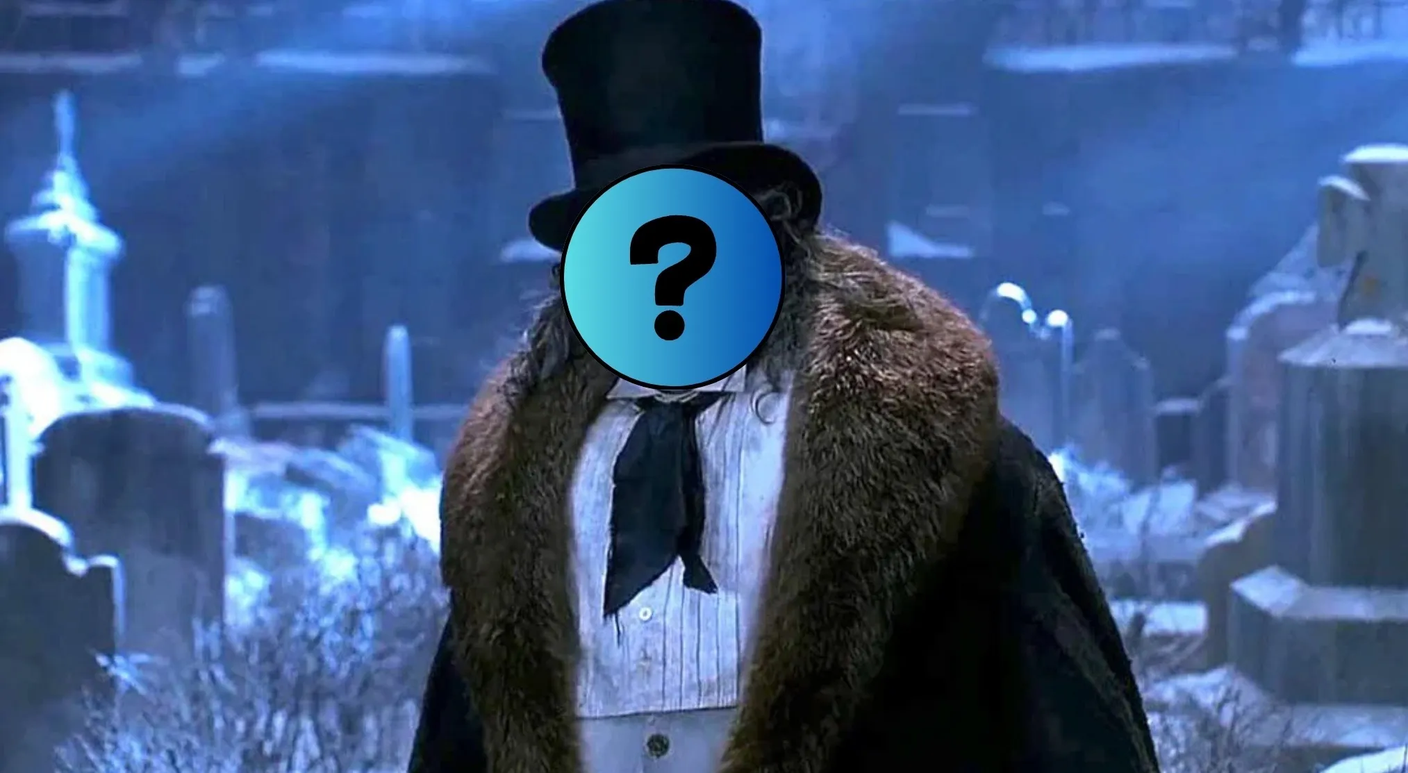 Guess the Batman movie villain! A figure in a top hat, fur coat, and white shirt, with a question mark obscuring their face, stands in a snowy graveyard.