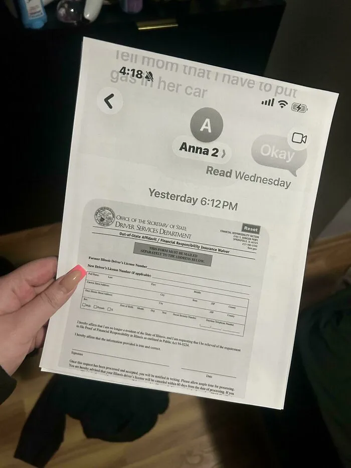 A person holding a document over a phone screen with messages about putting gas in a car, highlighting a dumb moment.