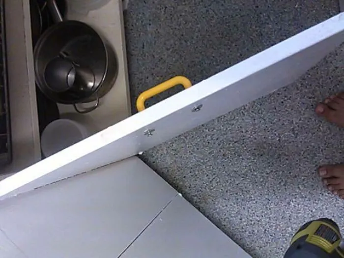 A door with a handle installed on the wrong side, making it dumb and impractical to open.