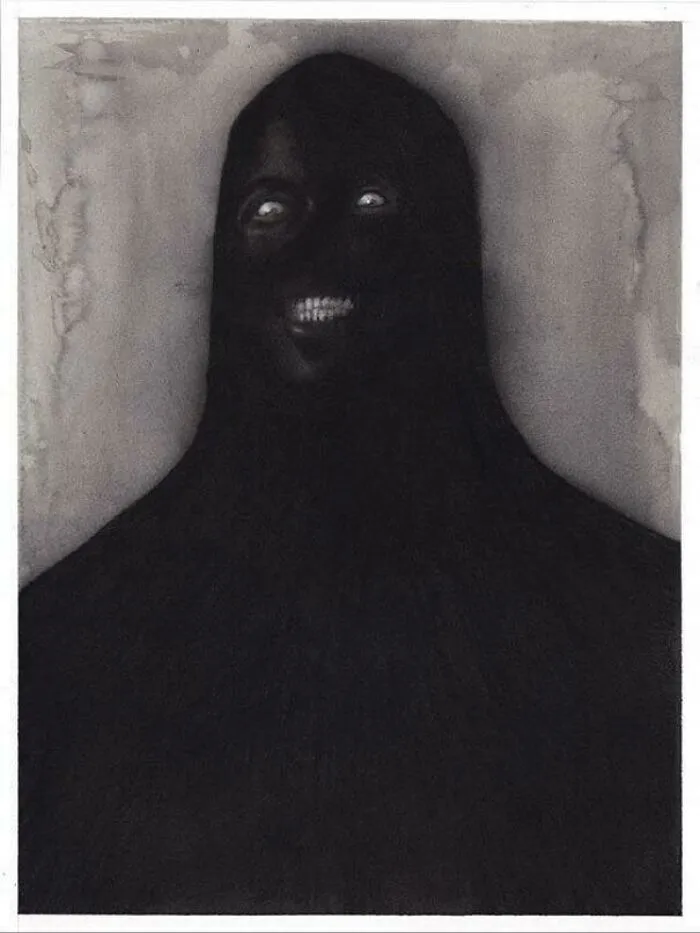 Unsettling picture of a dark, hooded figure with glowing eyes and a menacing smile, against a light background.