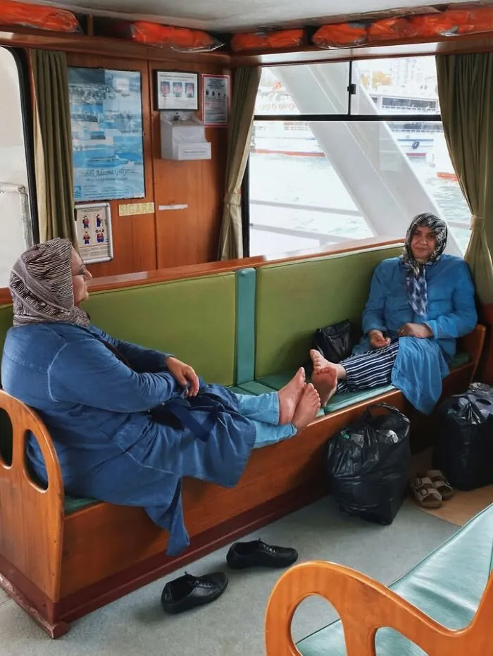 Two women relaxing on a boat, captured as a well-timed street shot.