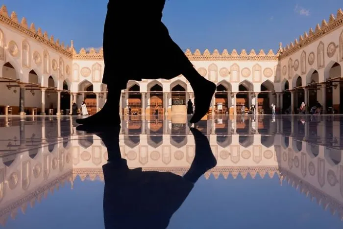 Murat Bakmaz captures the easily missed beauty of everyday life: A person's silhouette walks across a reflective floor in an ornate building.