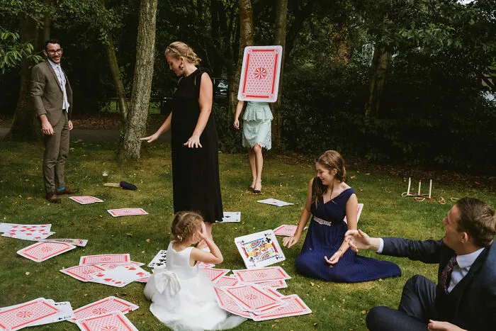 People playing with oversized cards outdoors, a whimsical scene from the Edge Street Photography Awards.